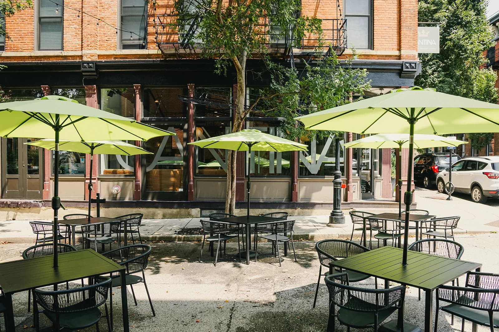 Crown Cantina's Broadway patio with its signature olive-green umbrellas
